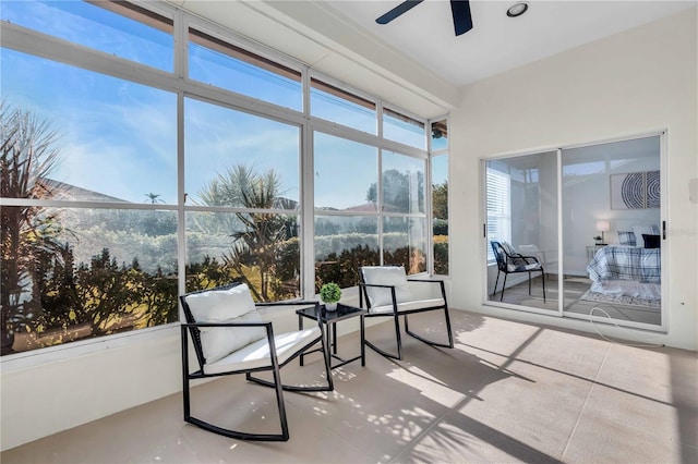 sunroom / solarium featuring ceiling fan and a mountain view