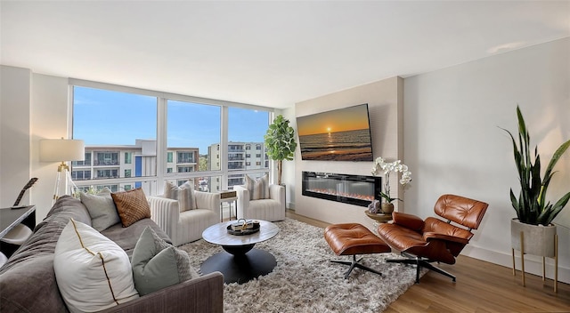 living room featuring plenty of natural light, hardwood / wood-style floors, and expansive windows