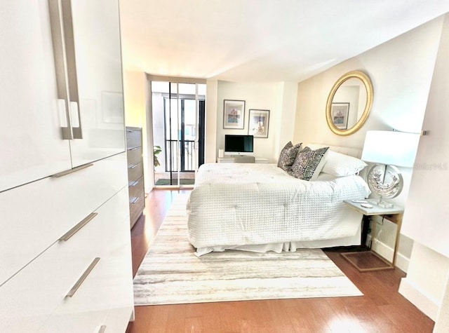 bedroom with dark hardwood / wood-style floors