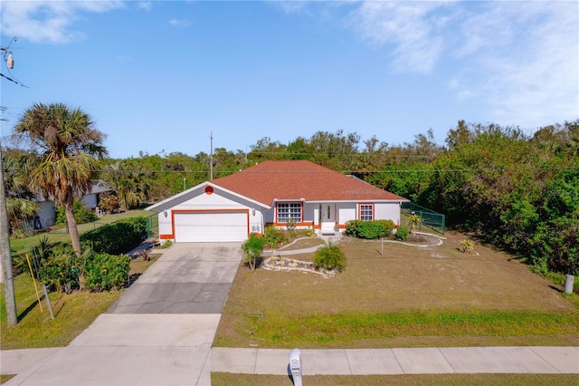 ranch-style home with a front yard and a garage