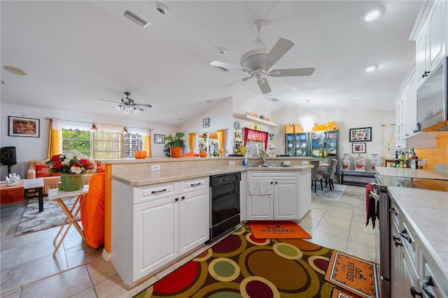 kitchen featuring ceiling fan with notable chandelier, pendant lighting, white cabinetry, stainless steel electric range oven, and lofted ceiling