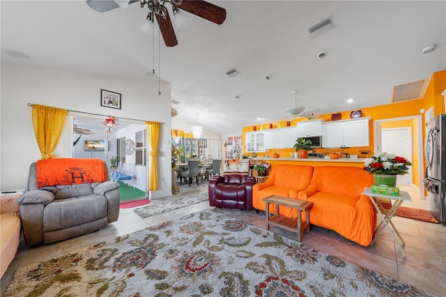 tiled living room featuring ceiling fan and lofted ceiling