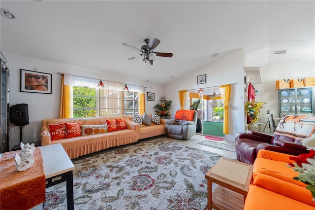 living room featuring ceiling fan, a healthy amount of sunlight, and lofted ceiling