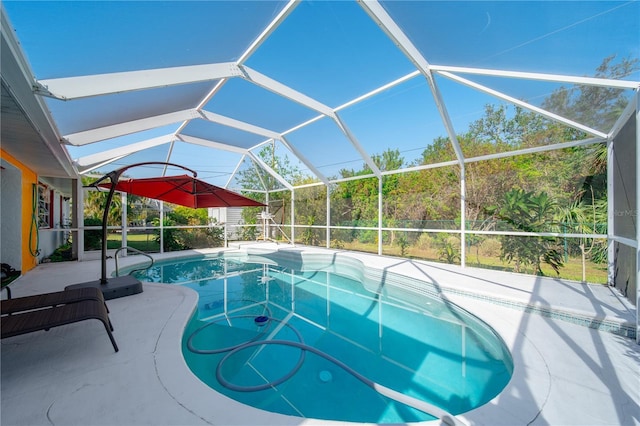 view of pool with a lanai and a patio area