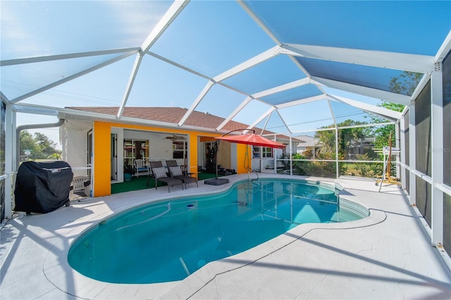 view of pool with a patio, area for grilling, ceiling fan, and a lanai