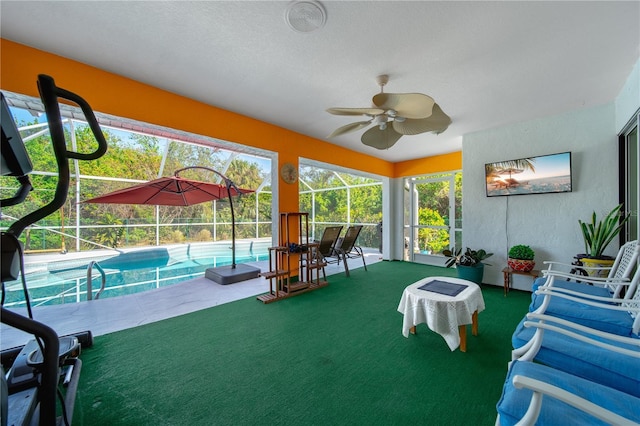 sunroom / solarium featuring ceiling fan