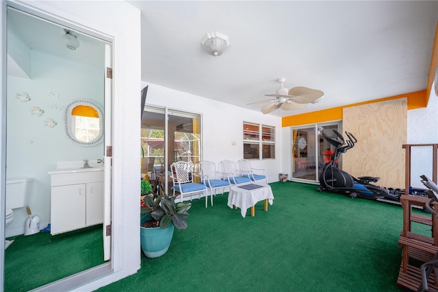 interior space featuring ceiling fan and sink