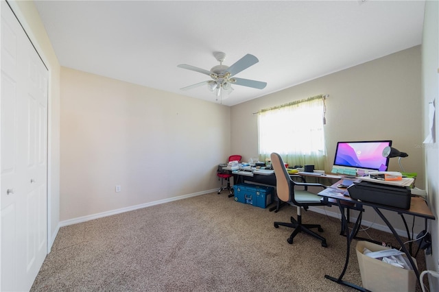 carpeted home office featuring ceiling fan