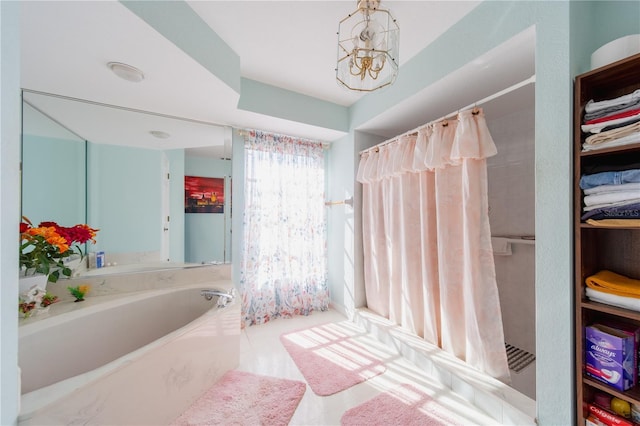 bathroom featuring tile patterned flooring, a notable chandelier, and shower with separate bathtub