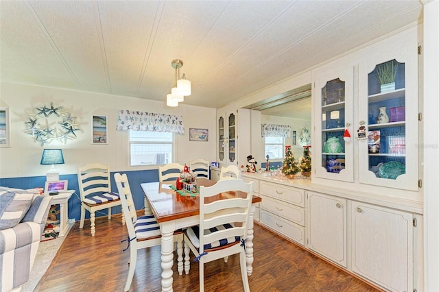 dining room featuring a textured ceiling and dark wood-type flooring