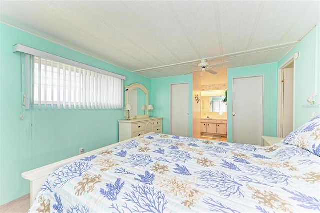 bedroom featuring carpet flooring, ceiling fan, and connected bathroom