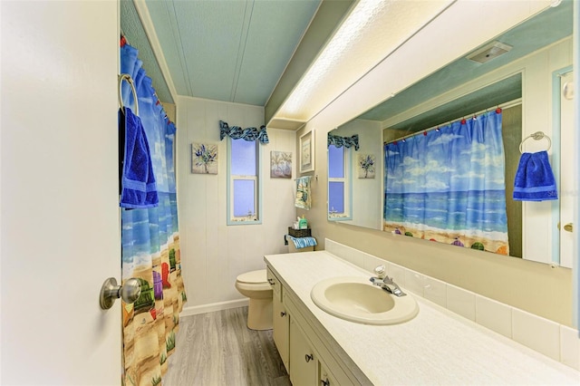 bathroom with hardwood / wood-style floors, vanity, and toilet