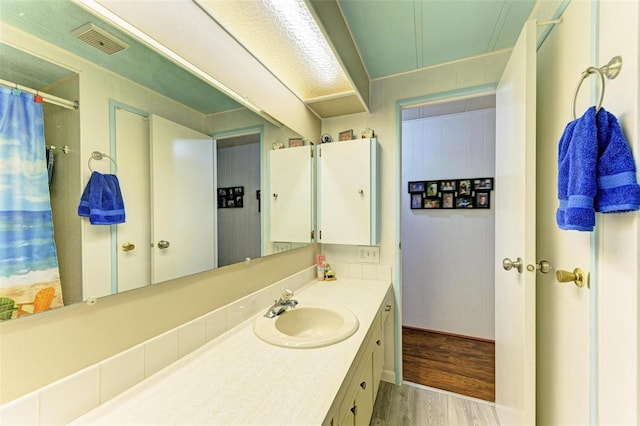 bathroom featuring vanity and wood-type flooring