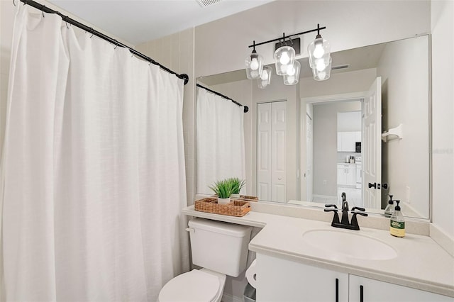 bathroom featuring vanity and toilet