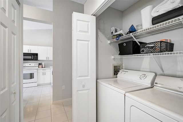 washroom with light tile patterned floors and separate washer and dryer