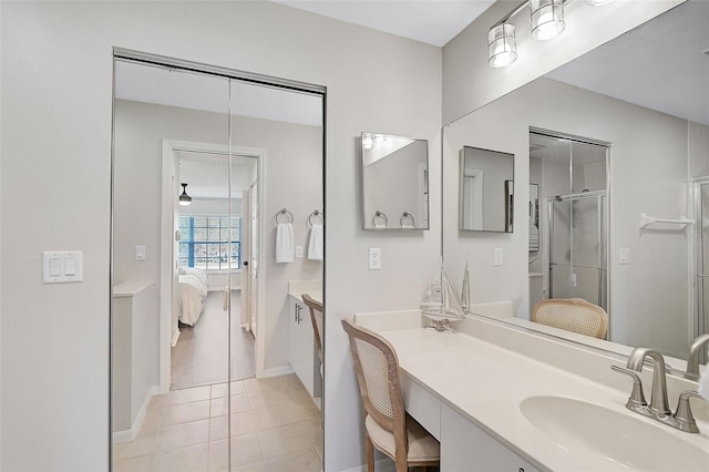 bathroom with tile patterned floors, vanity, and a shower with shower door