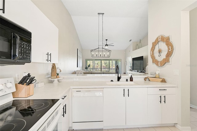 kitchen with white cabinets, white appliances, sink, and vaulted ceiling