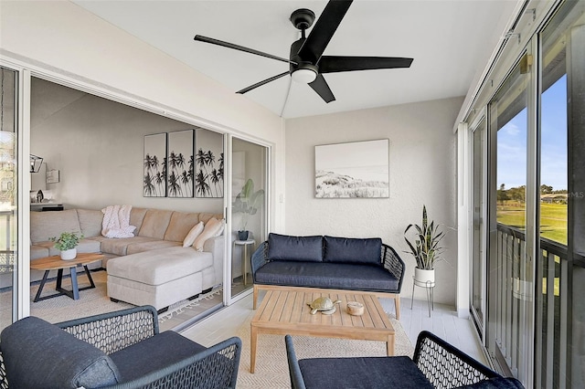 living room featuring light hardwood / wood-style floors, vaulted ceiling, and ceiling fan