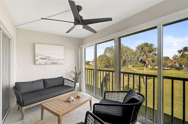 sunroom featuring ceiling fan