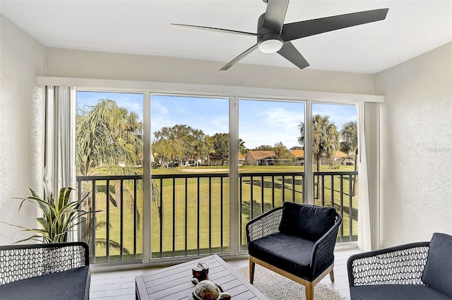 sunroom / solarium with a wealth of natural light and ceiling fan