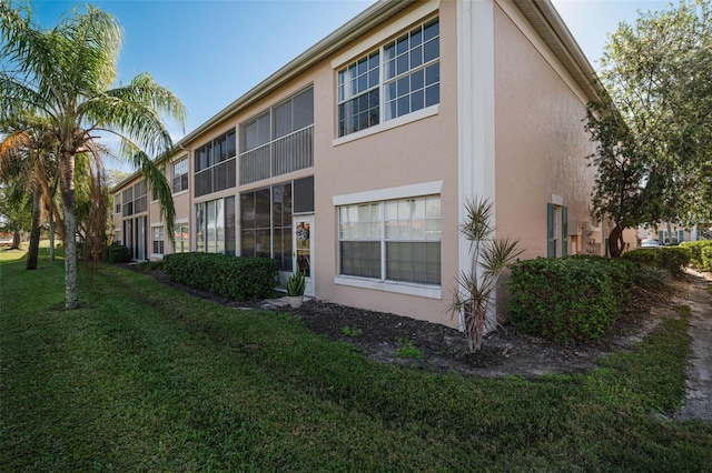 rear view of property with a lawn