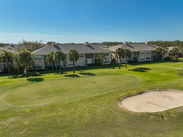 view of property's community with a yard