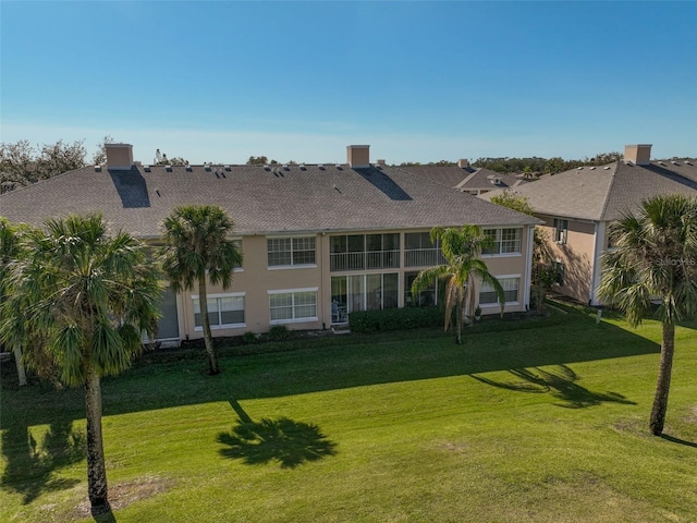 rear view of property featuring a yard