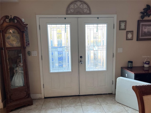 doorway with light tile patterned flooring and french doors