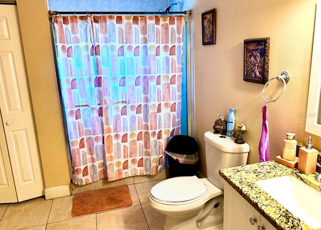 bathroom with toilet, a shower with curtain, vanity, and tile patterned floors