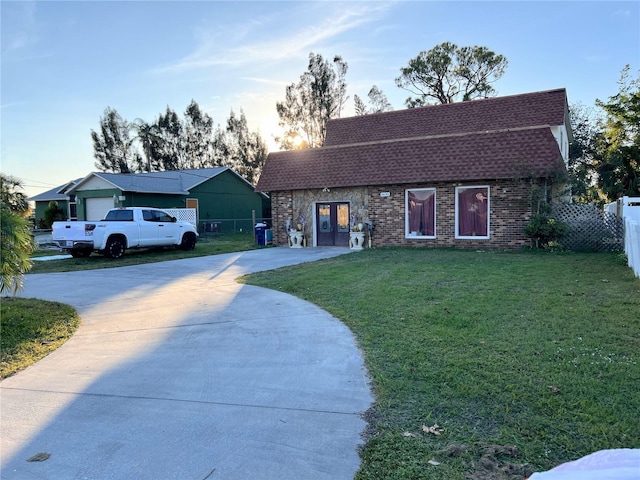 5630 3rd St W, Bradenton, FL 34207 - view of front facade with driveway, roof with shingles, and french doors