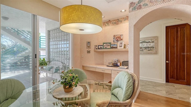 dining space featuring built in desk and light wood-type flooring