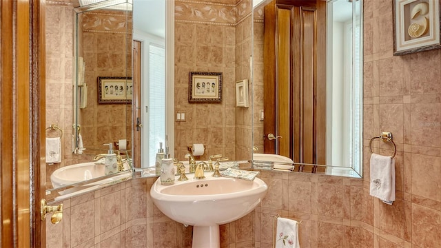 bathroom with tile walls and sink