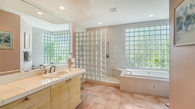 bathroom with vanity, tile patterned floors, and independent shower and bath