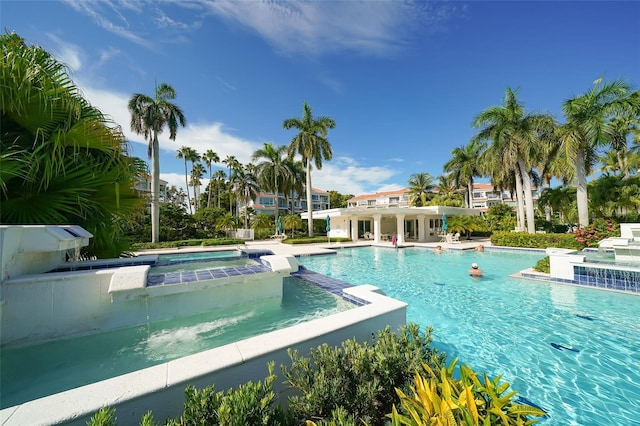 view of pool with an in ground hot tub