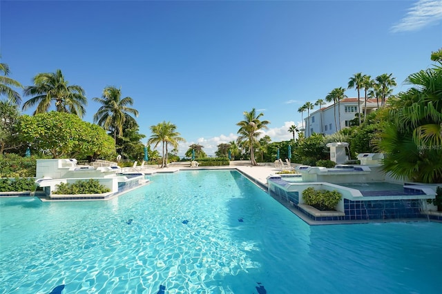 view of swimming pool with a jacuzzi and pool water feature