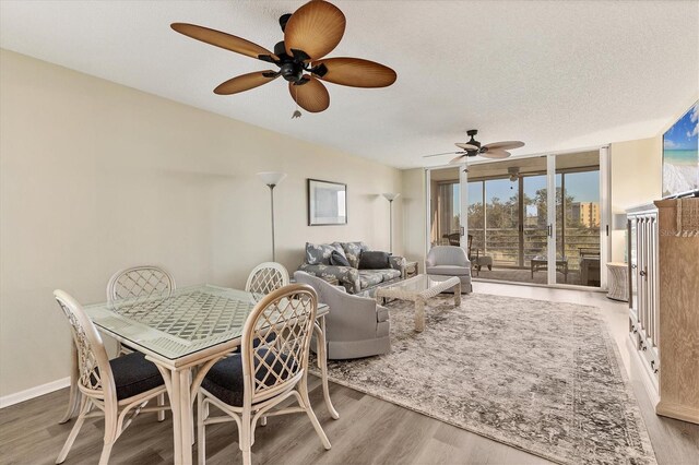 dining space featuring a textured ceiling, light hardwood / wood-style flooring, and ceiling fan