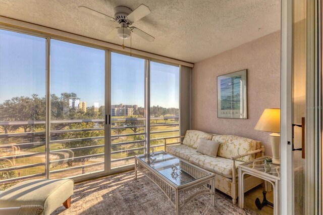 sunroom featuring ceiling fan