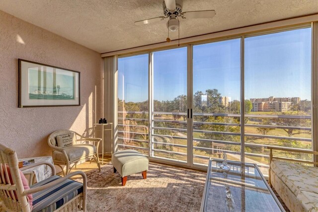 sunroom featuring ceiling fan and a healthy amount of sunlight