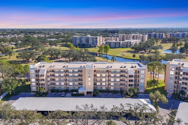 bird's eye view with view of golf course and a water view