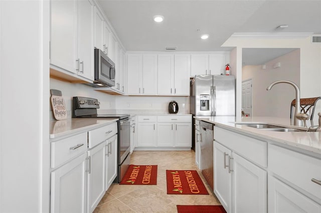 kitchen with white cabinets, sink, light stone countertops, light tile patterned floors, and appliances with stainless steel finishes