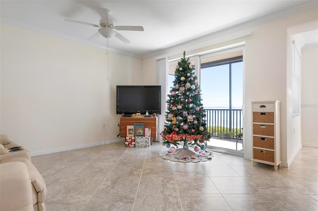 tiled living room with ceiling fan, plenty of natural light, and crown molding