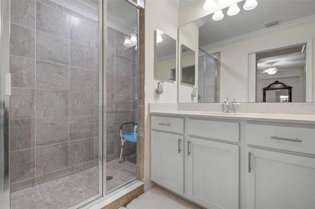 bathroom with vanity, ceiling fan, an enclosed shower, and crown molding