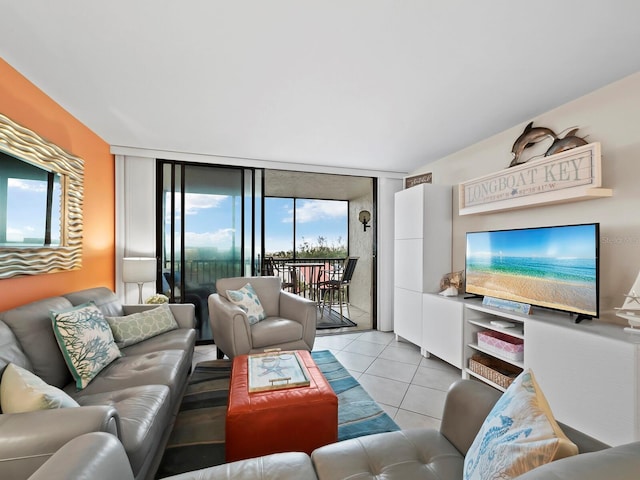 tiled living room featuring a wall of windows