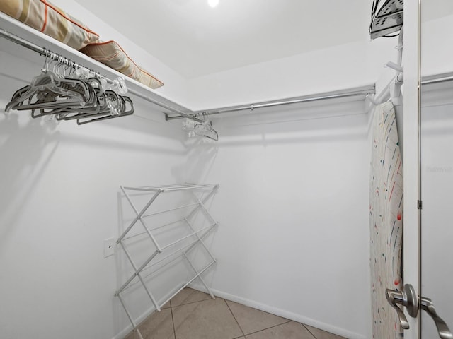 spacious closet featuring light tile patterned floors