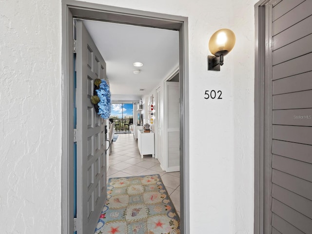 corridor featuring light tile patterned floors