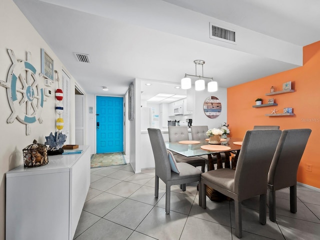 dining room featuring light tile patterned floors and washer / clothes dryer