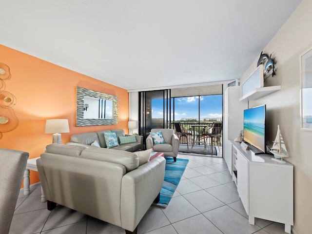 living room featuring expansive windows and light tile patterned floors