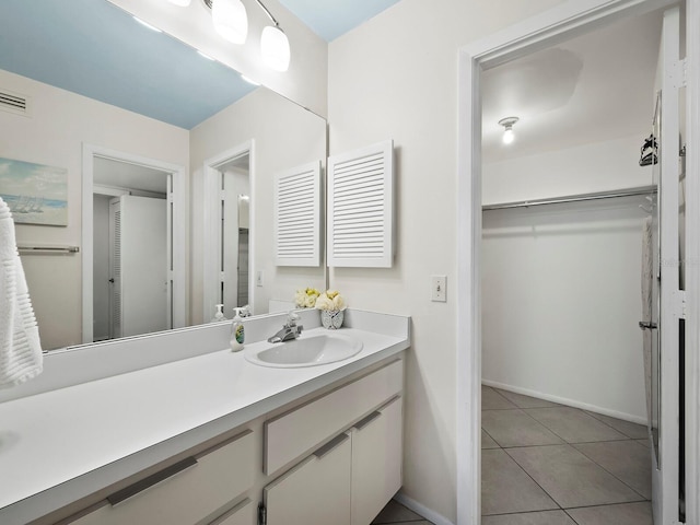 2045 Gulf Of Mexico Dr Unit M1-502, Longboat Key, FL 34228 - bathroom with vanity, a walk in closet, and tile patterned flooring
