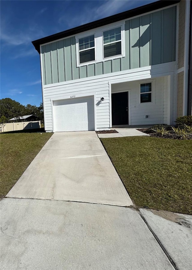 view of front facade with a front yard and a garage