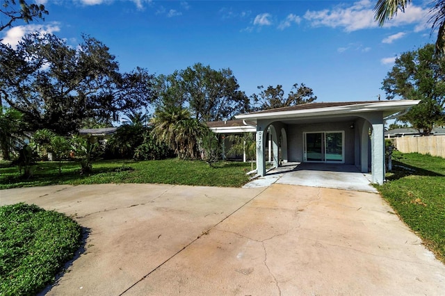 exterior space with a lawn and a carport